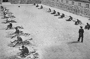 Prisoners crushing stone at the Robben Island B-Section courtyard. (UWC-Robben Island Mayibuye Archives)